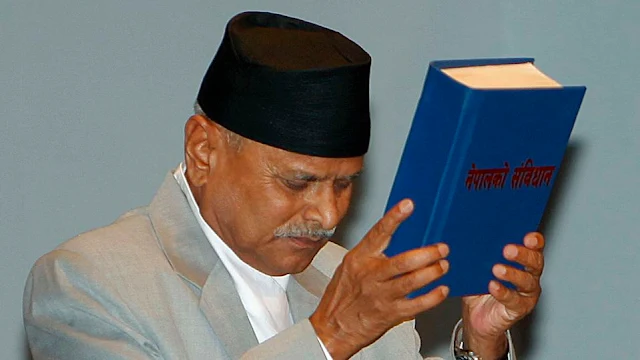 Image Attribute: Nepalese President Ram Baran Yadav with the Constitution / Source: Creative Commons