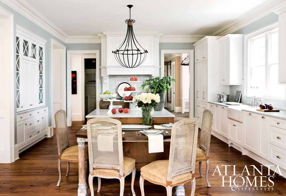 White kitchen with traditional style, blue walls, and vintage cane dining chairs