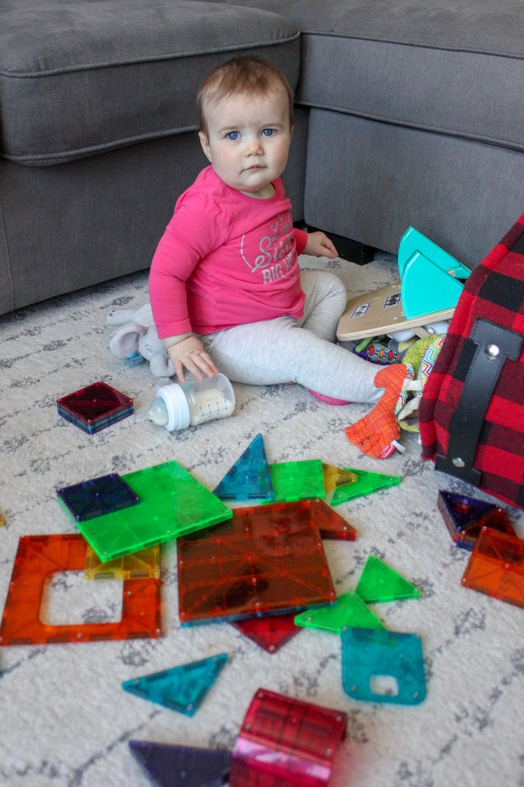 baby playing with magnetic tiles