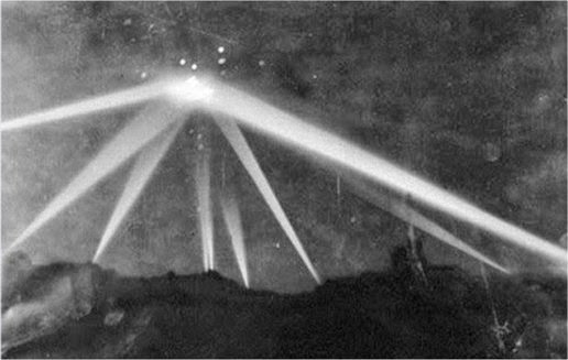 Spotlights focus on unidentified object above Los Angeles on February 25, 1942. The bright point flashes around the area it was a blast anti-aircraft guns. Spotlights focus on unidentified object above Los Angeles on February 25, 1942. The bright point flashes around the area it was a blast anti-aircraft guns.
