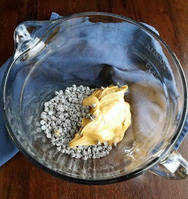 glass bowl with peanut butter and chocolate chips chocolate chips and peanut butter in glass bowl