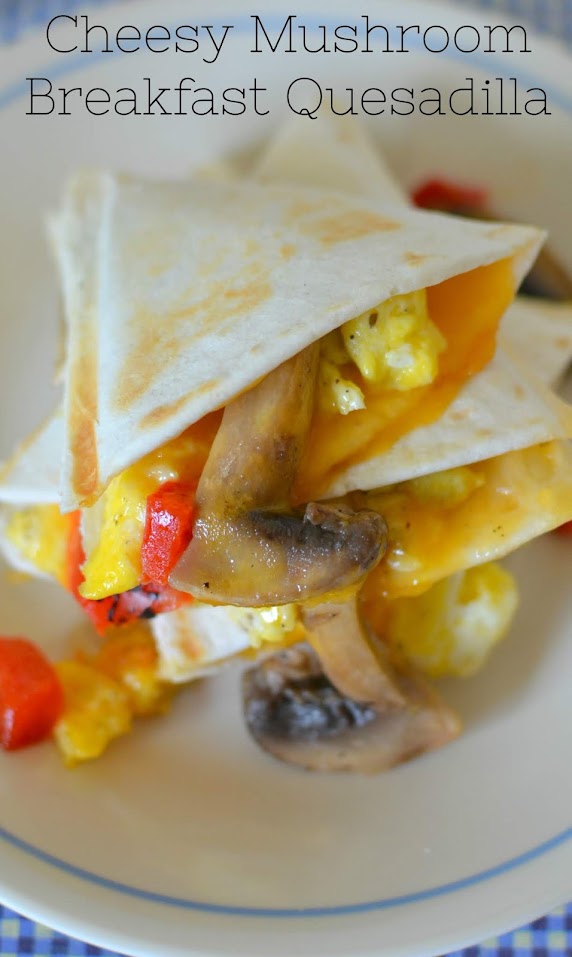Cheesy Mushroom Breakfast Quesadilla Recipe from Hot Eats and Cool Reads! These delicious mushroom quesadillas are packed with scrambled eggs, roasted red peppers and shredded cheddar cheese! Such a great way to start the day!