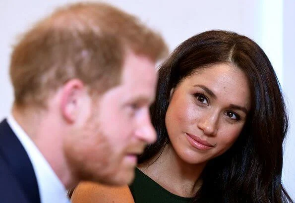 Meghan Markle carried Montunas mini guaria bag, She wore Sentaler wap coat, P.A.R.O.S.H. bow detail sleeveless dress