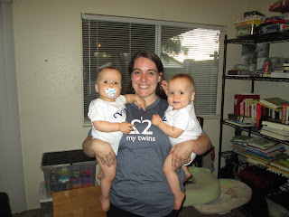 mom holding her twin daughters, all wearing my twins are cuter shirts