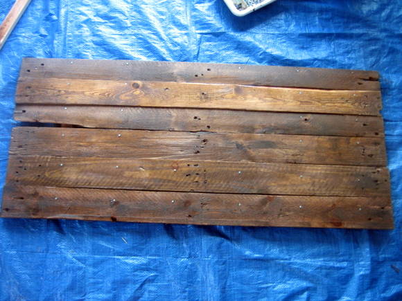 Making a DIY pallet sign out of refurbished wood. 