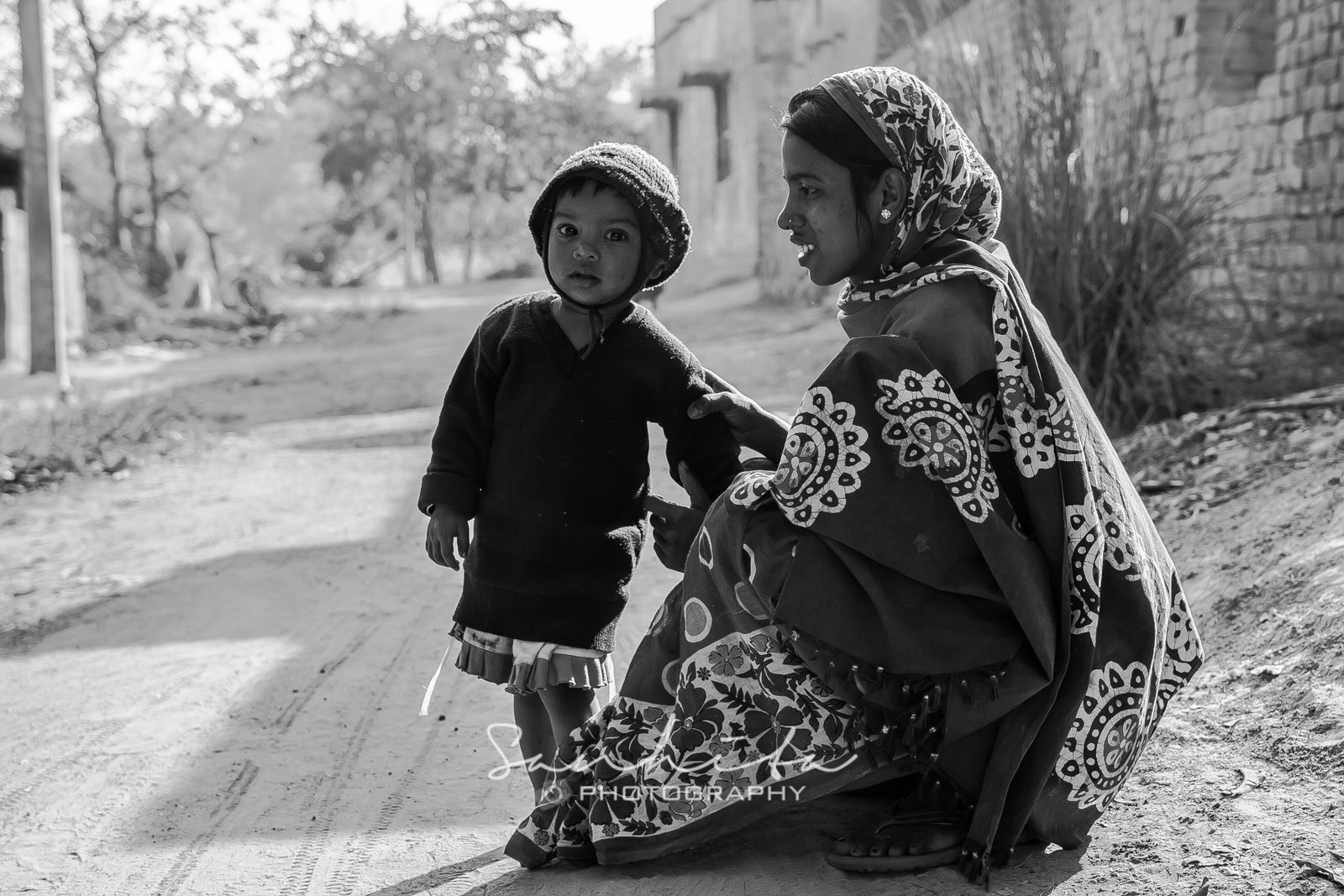 A four year old girl standing with her mom