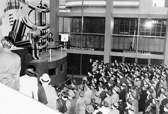 Jamming every inch of space in the huge Hall of Electrical Living at the Westinghouse Building at the World's Fair, crowds stand 6 deep on the sidewalk outside the glass-enclosed structure to watch Elektro, the Westinghouse Moto-Man, perform his 26 mechanical tricks, including, walking, talking, smoking a cigarette and counting, on May 8, 1939.