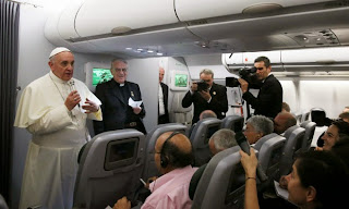 Pope Francis in an aeroplane