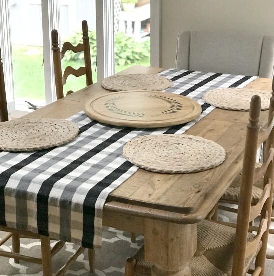 Farmhouse table with placemats and buffalo check runner