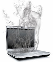 Picturer of a laptop computer with smoke rising from it