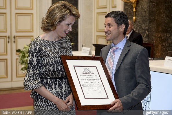Queen Mathilde of Belgium speaks with Professor Patrice Cani who received the 2015 grant fo medical research during a ceremony for the Inbev-Baillet Latour awards for Health and Clinical Research in Brussels