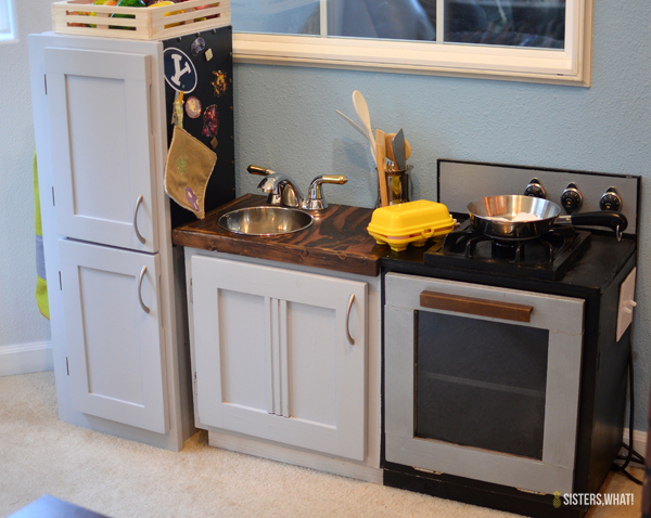 This little play kitchen was made from old cabinets and includes electricity for a fake oven and stovetop!