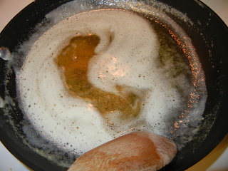 butter completely melted in a pan with a wooden spoon 