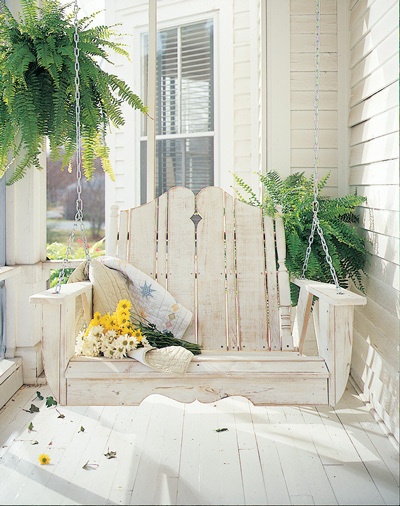 This whitewashed front porch swing is a great place to curl up with a book and enjoy the sunshine