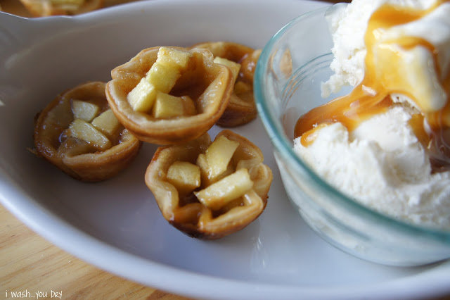 A display of Apple Pie Tartlets in a dish next to a bowl of caramel topped ice cream. 