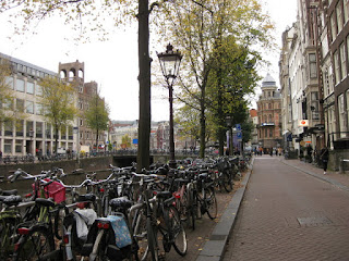Bicycles parked three and four deep alongside a canal, Amsterdam, The Netherlands
