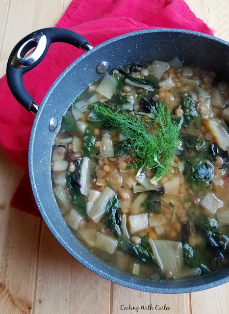 Fresh garden vegetables meet lentils for a hearty and delicious vegetarian soup. This easy, healthy and delicious soup makes for a perfect lunch or dinner year round! pot of soup full of fresh vegetables and lentils