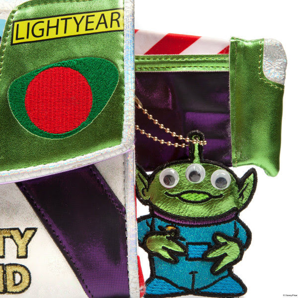 Irregular Choice Disney Toy Story Falling With Style bag alien charm small metallic alien charm with googly eyes dangling from side of metallic handbag