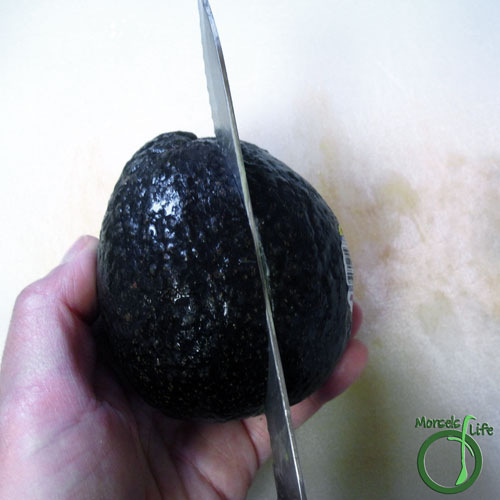 Morsels of Life - How to Cut an Avocado Step 2 - Slice avocado in half, twisting slightly to separate two halves.