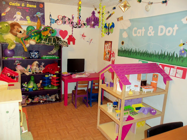 Playroom with bright colors, pink, purple, and big Kidkraft So Chic Dollhouse