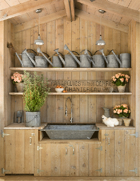 A collection of vintage watering cans and flowerpots 