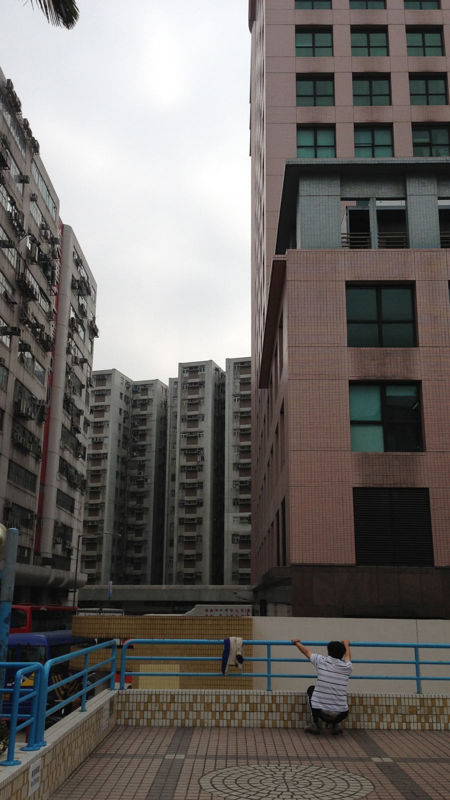 A man does his morning stretches at the To Kwa Wan Recreation Grounds.