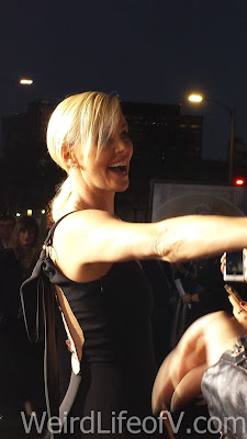 The Huntsman: Winter's War Red Carpet Premiere Charlize Theron smiling at fans in the fan pit.