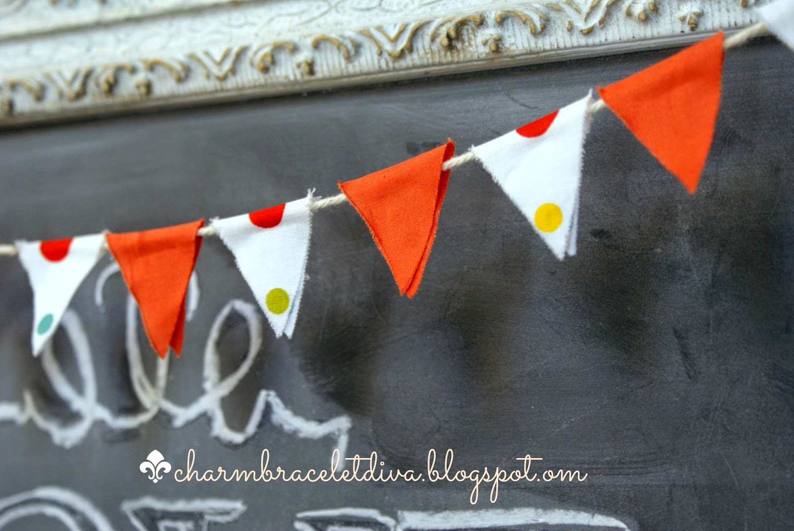 orange and polka dot mini bunting hanging on vintage picture frame