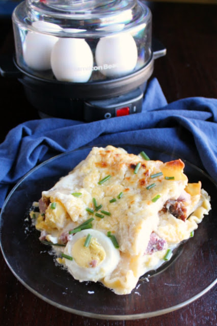 Croque madame inspired lasagna is perfect for breakfast, brunch or dinner. Bonus: it's also a great way to use leftover ham and hard boiled eggs from Easter! slice of croque madame lasagna with egg cooker in background