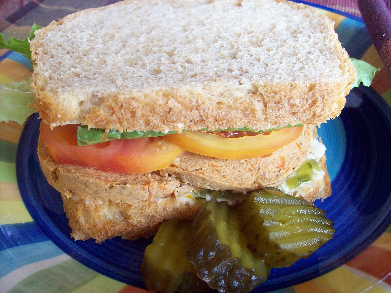 Sandwich Deli Loaf in a sandwich of whole wheat bread, lettuce, tomatoes and pickles.