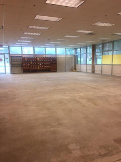 Magazine and PC Area Concrete floors and wall shelving in large open area
