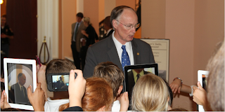 Students from Daphne East Elementary taking pictures of Governor of Alabama, Robert Bentley with iPads and other smart phones.