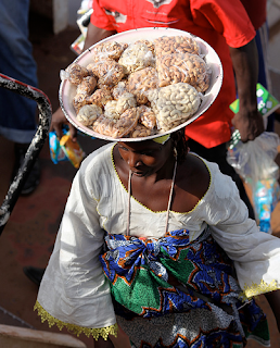 African street food vendor selling cashew nuts in Nigeria