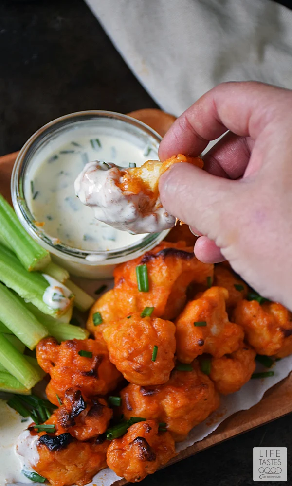 Baked Buffalo Cauliflower Bites | by Life Tastes Good with a dairy-free ranch dipping sauce are loaded with all the flavors of one of our favorite Monday Night Football appetizers, but in a better-for-you option. These spicy bites are meatless and dairy free too! #LTGrecipes