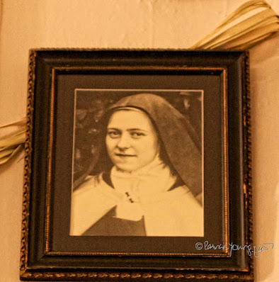 This picture is of a framed photo of  St. Thérèse de Lisieux.