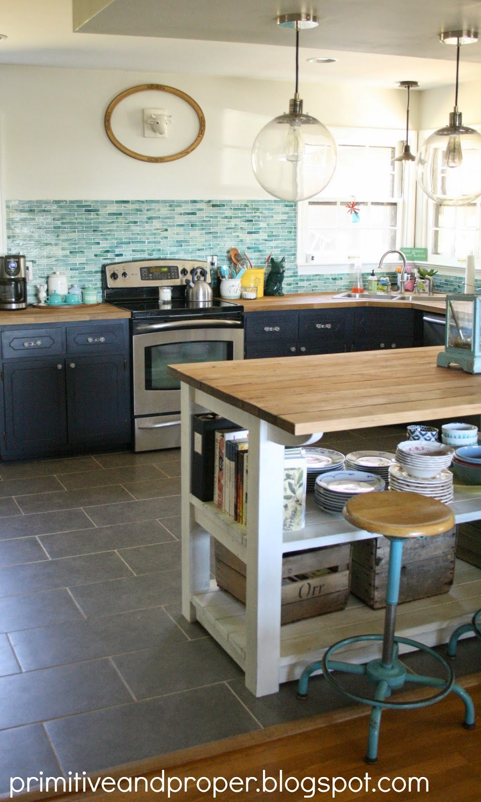 A glass green backsplash on the wall in the kitchen.