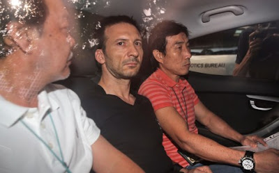 Belgian national Philippe Graffart (center) arrives at the state court in Singapore. Belgian national Philippe Graffart (center) arrives at the state court in Singapore.