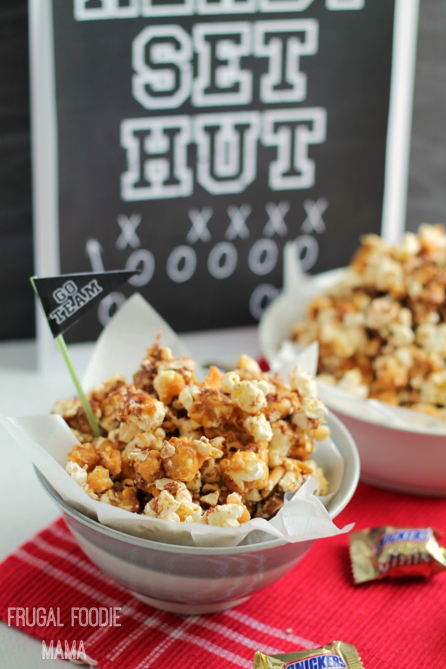This MVPeanut Butter Snickers Popcorn with it's crunchy popcorn, gooey peanut butter, and bits of Snickers is the perfect sweet treat for game day.