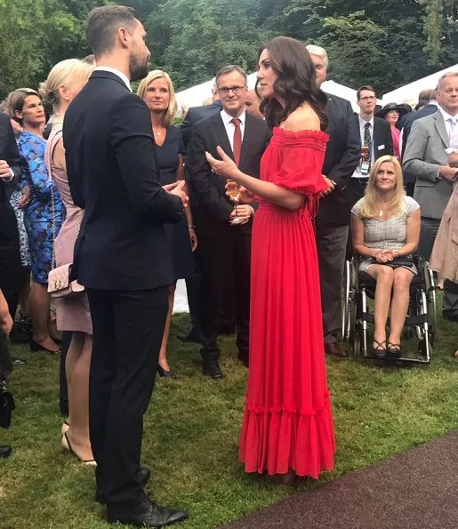 Kate Middleton's dress is by Alexander McQueen Off-the-shoulder shirred cotton and silk-blend. Simone Rocha Crystal earrings, Prada Pumps, Club Monaco Channon Heeled Sandal
