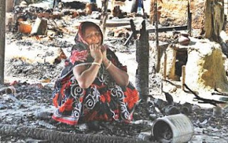 Having lost everything, Nipu Sheel wails sitting on the debris of her house that was set ablaze by Jamaat-Shibir men at Banshkhali in Chittagong