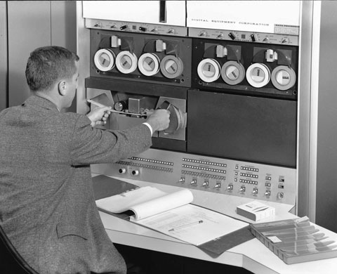 Operator programming a PDP-6 using papertape