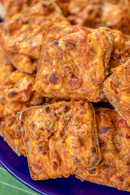 Taco Party Toasts - only 5 ingredients!! Seriously delicious! I took these to a party and they were gone in a flash. Ground beef, taco seasoning, diced tomatoes and green chiles, Velveeta cheese and party rye bread. Can make ahead of time and freezer for later. Great for any occasion - parties, tailgating or a quick lunch or dinner. Taco night was never so fun! #appetizer #taco #tailgating #partyfood Taco Party Toasts - only 5 ingredients!! Seriously delicious! I took these to a party and they were gone in a flash. Ground beef, taco seasoning, diced tomatoes and green chiles, Velveeta cheese and party rye bread. Can make ahead of time and freezer for later. Great for any occasion - parties, tailgating or a quick lunch or dinner. Taco night was never so fun! #appetizer #taco #tailgating #partyfood