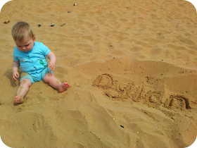 baby at the beach, writing in the sand, Dylan