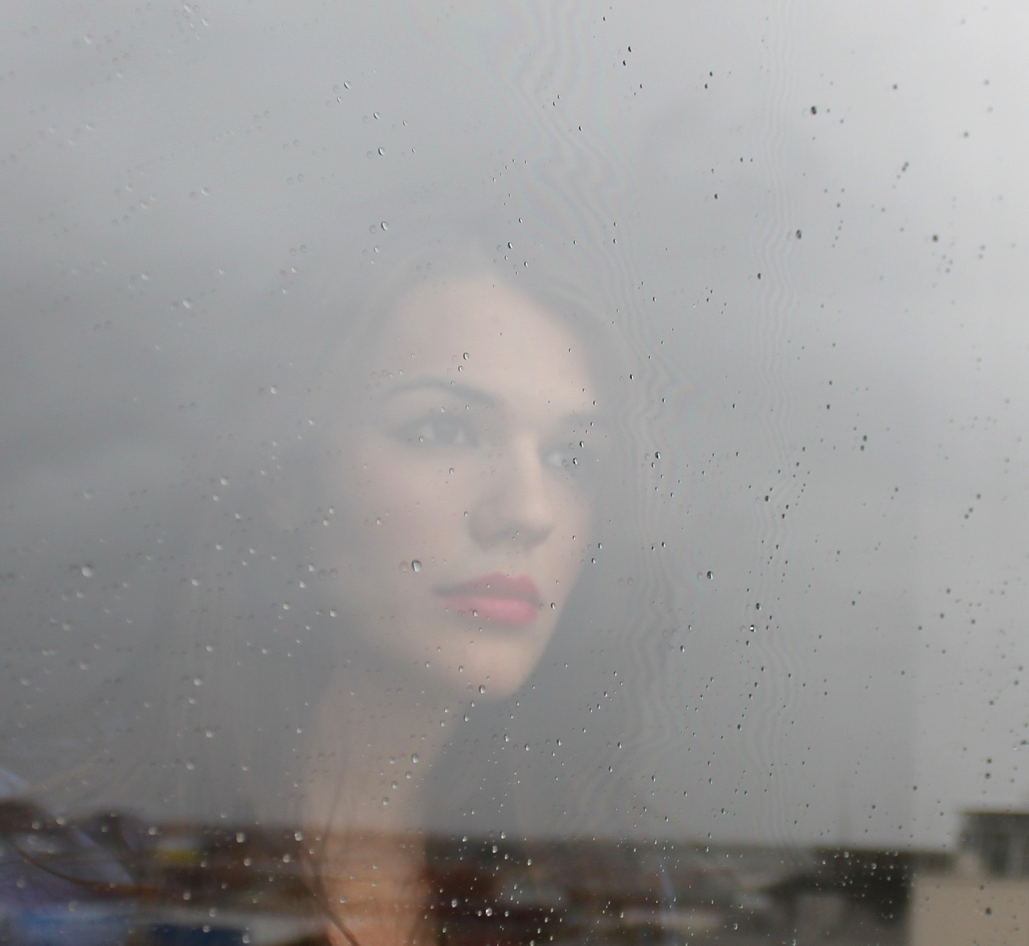 Woman looking out a window. Woman looking out a window.