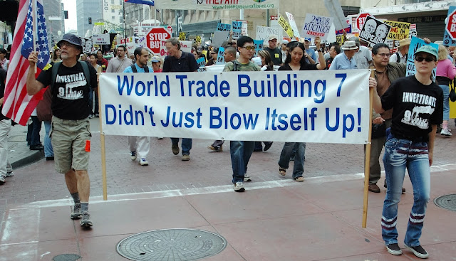 9-11 Protests at the World Trade Center Protesters in New York City carry saying "World Trade Center Building 7 didn't just blow itself Up!"