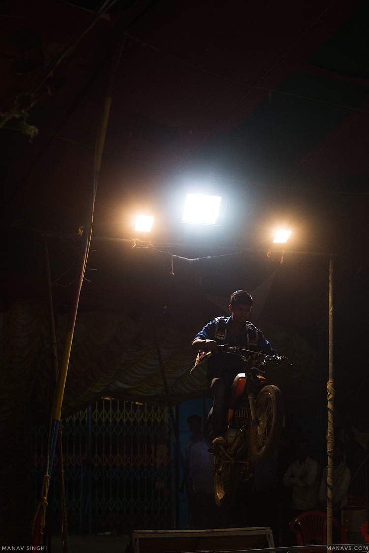 A Guy performing Motorcycle Stunt at Indian Circus, on the occasion of Sheetala Ashtami Fair at Chaksu Village, Near Jaipur.