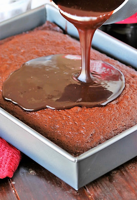 Pouring Chocolate Icing on Top of Chocolate Cake Image