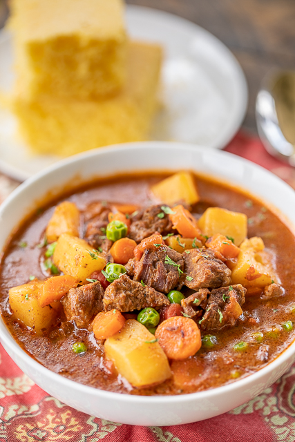 Instant Pot Beef Stew - comfort food at its best! Seriously THE BEST beef stew recipe we've ever eaten! SO simple. Just sauté the stew meat, dump the rest of the ingredients in the pot and cook. Only about 5 minutes of hands on time! Stew meat, flour, sugar, beef broth, diced tomatoes, chili powder, thyme, Worcestershire sauce, tomato paste, onion, garlic, potatoes, carrots, and peas. Leftovers also taste great reheated! #instantpot #beef #stew Instant Pot Beef Stew - comfort food at its best! Seriously THE BEST beef stew recipe we've ever eaten! SO simple. Just sauté the stew meat, dump the rest of the ingredients in the pot and cook. Only about 5 minutes of hands on time! Stew meat, flour, sugar, beef broth, diced tomatoes, chili powder, thyme, Worcestershire sauce, tomato paste, onion, garlic, potatoes, carrots, and peas. Leftovers also taste great reheated! #instantpot #beef #stew