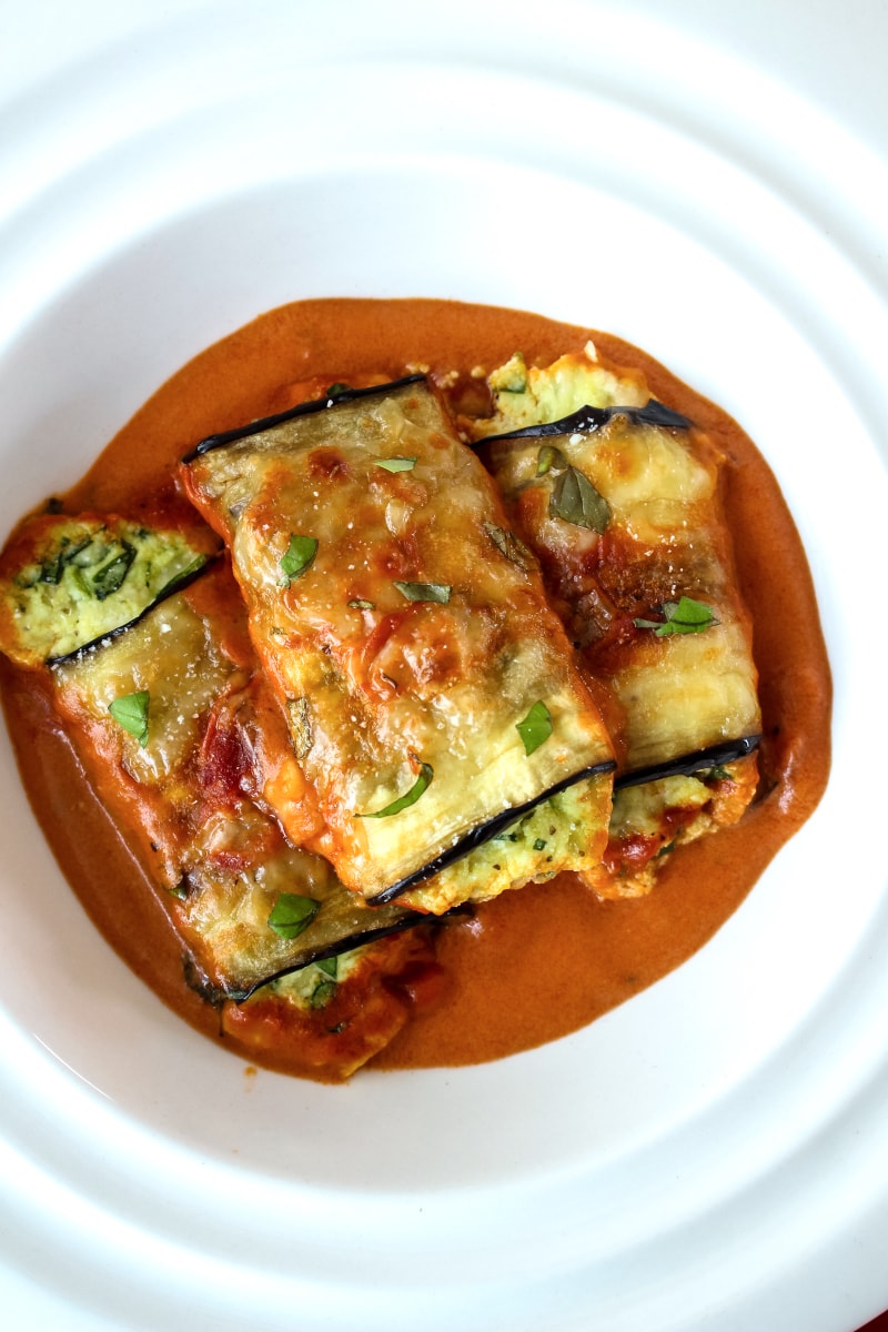 Eggplant Rollatini Rosa is a meatless dinner that features cheese and spinach stuffed eggplant baked in a creamy mixed Rosa Sauce. It is the perfect dinner recipe for your next special occasion! #eggplant #dinnerrecipe @Bertolli #sponsored