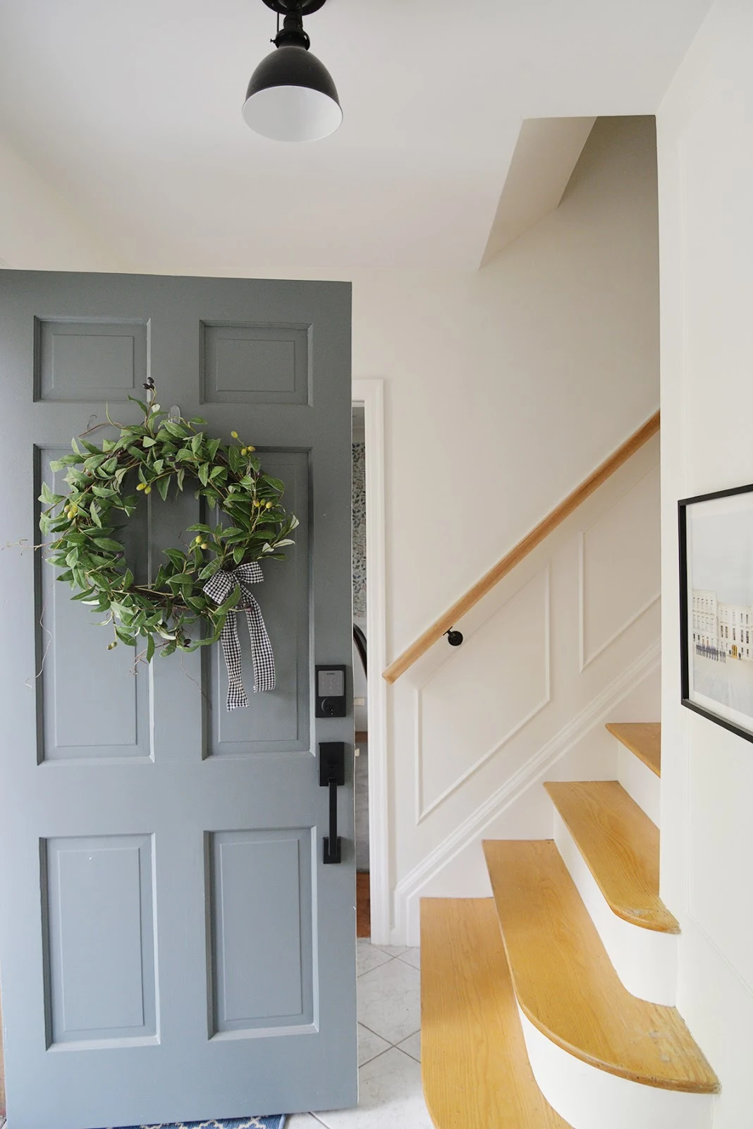 olive wreath on a front door, smart front door lock, grey green painted door